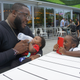 Kamal Muhammad feeds his son Zakai, while his daughter Zala talks to her mother on the phone in October of 2018. Ra is calling from prison.